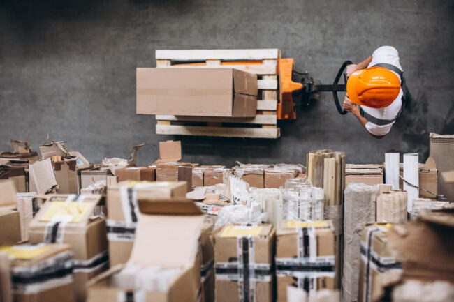 young-man-working-at-a-warehouse-with-boxes